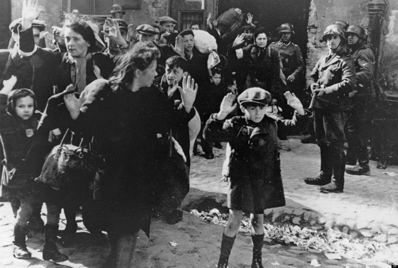 FILE- In this April 19, 1943 file photo, a group of Jews are escorted from the Warsaw Ghetto by German soldiers. (AP Photo/File)